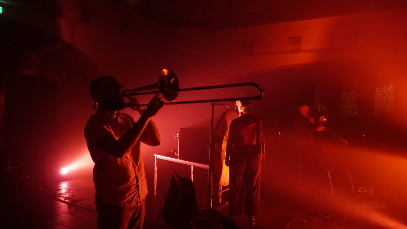 trombone player in red light and haze